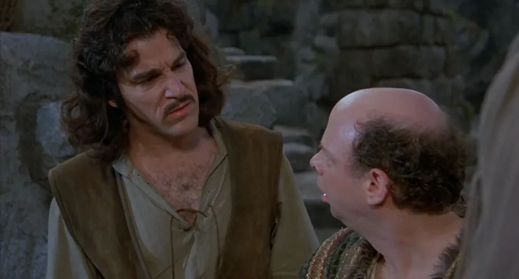 Cena de A Princesa Prometida, swashbuckler de fantasia dos anos 90, onde Inigo Montoya solta uma das suas frases mais conhecidas "Você continua usando essa palavra. Eu não acho que significa o que você acha que significa"