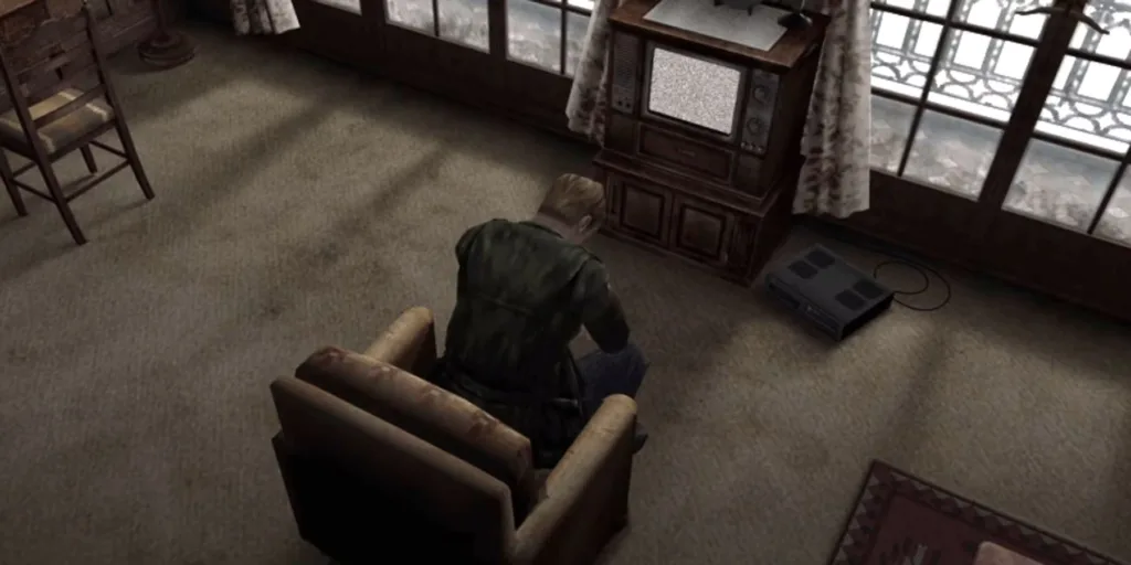 James, protagonista de Silent Hill 2, está num quarto de hotel olhando para uma TV antiga, arrasado depois de descobrir a verdade sobre a morte da sua esposa